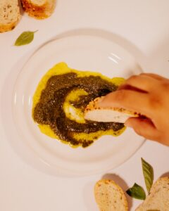 a white plate topped with bread and pesto